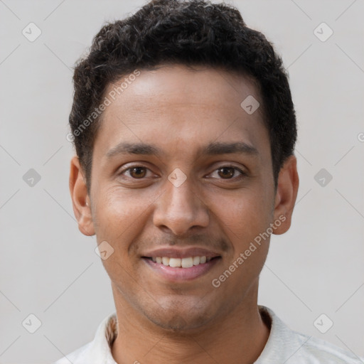 Joyful black young-adult male with short  brown hair and brown eyes