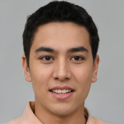 Joyful latino young-adult male with short  brown hair and brown eyes