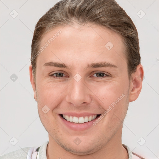 Joyful white young-adult female with short  brown hair and grey eyes