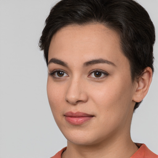 Joyful white young-adult female with short  brown hair and brown eyes