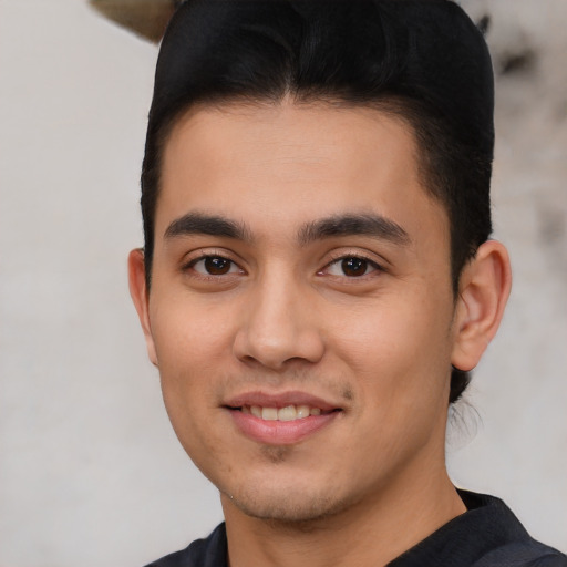 Joyful white young-adult male with short  black hair and brown eyes