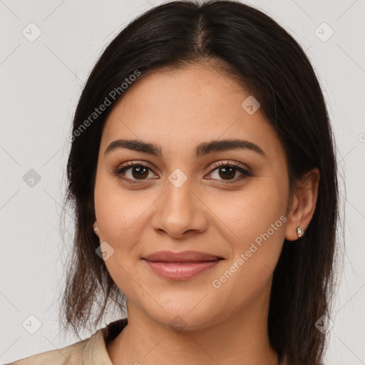 Joyful latino young-adult female with long  brown hair and brown eyes