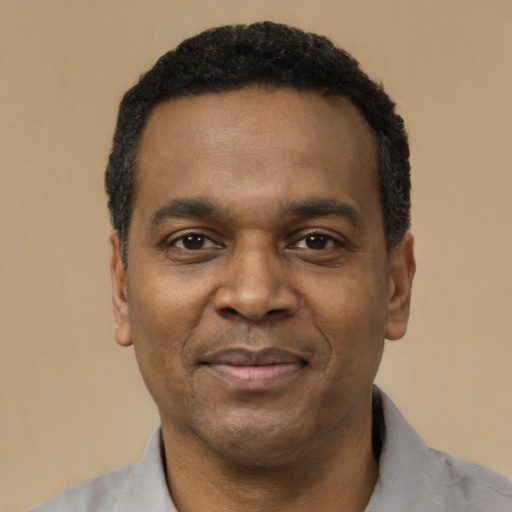 Joyful latino adult male with short  black hair and brown eyes
