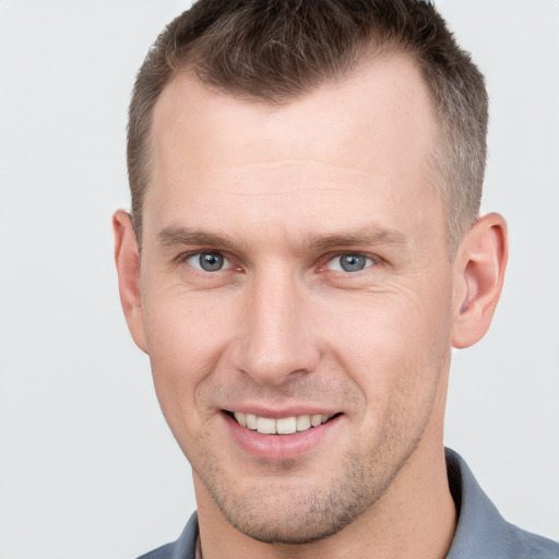 Joyful white adult male with short  brown hair and grey eyes