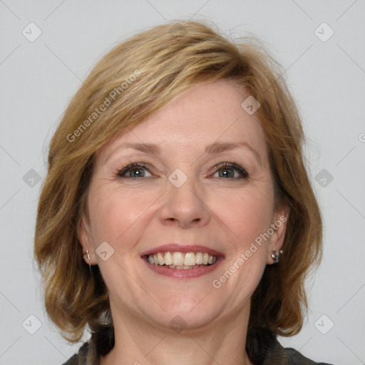 Joyful white adult female with medium  brown hair and blue eyes