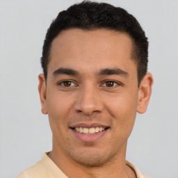 Joyful latino young-adult male with short  brown hair and brown eyes