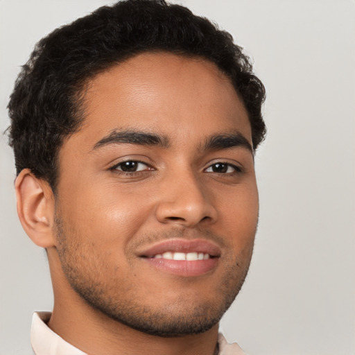 Joyful latino young-adult male with short  brown hair and brown eyes