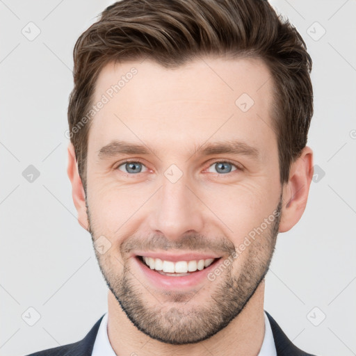 Joyful white young-adult male with short  brown hair and grey eyes