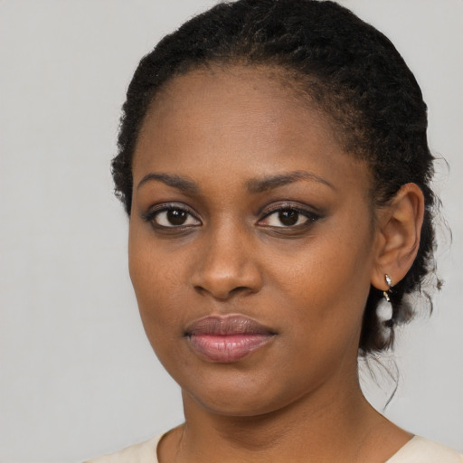 Joyful black young-adult female with medium  black hair and brown eyes