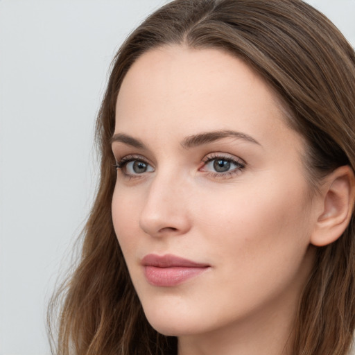 Neutral white young-adult female with long  brown hair and grey eyes