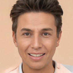 Joyful white adult male with short  brown hair and brown eyes