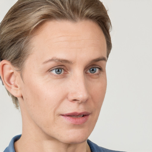 Joyful white adult female with short  brown hair and grey eyes