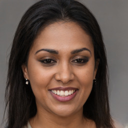 Joyful latino young-adult female with long  brown hair and brown eyes