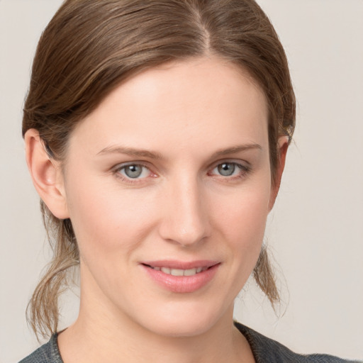 Joyful white young-adult female with medium  brown hair and grey eyes