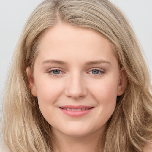 Joyful white young-adult female with long  brown hair and blue eyes