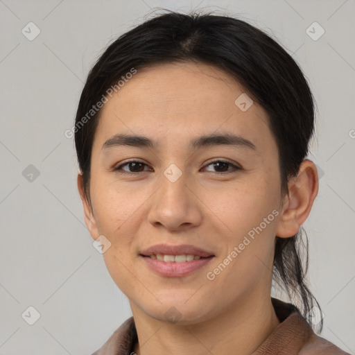 Joyful latino young-adult female with medium  brown hair and brown eyes