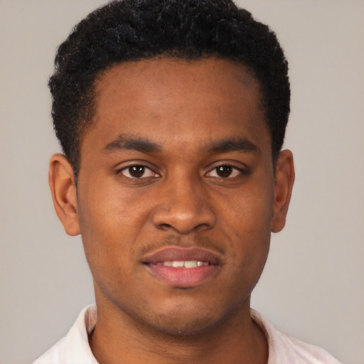 Joyful black young-adult male with short  brown hair and brown eyes