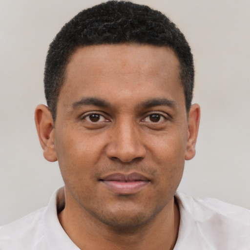 Joyful black young-adult male with short  brown hair and brown eyes