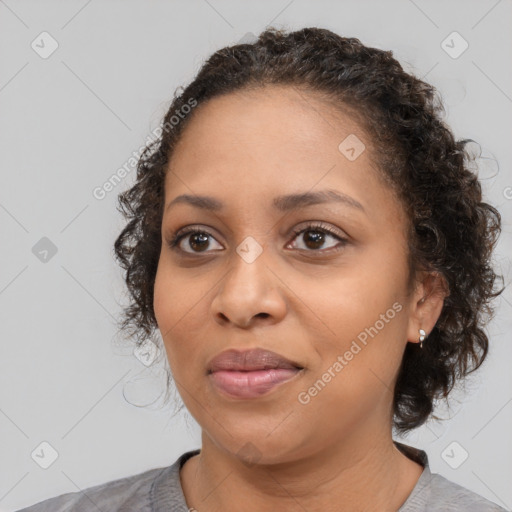 Joyful black young-adult female with medium  brown hair and brown eyes