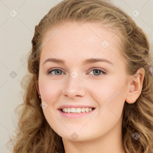 Joyful white young-adult female with long  brown hair and blue eyes