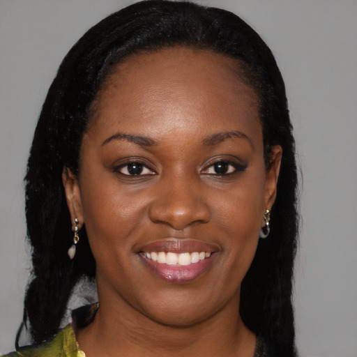 Joyful black young-adult female with long  brown hair and brown eyes