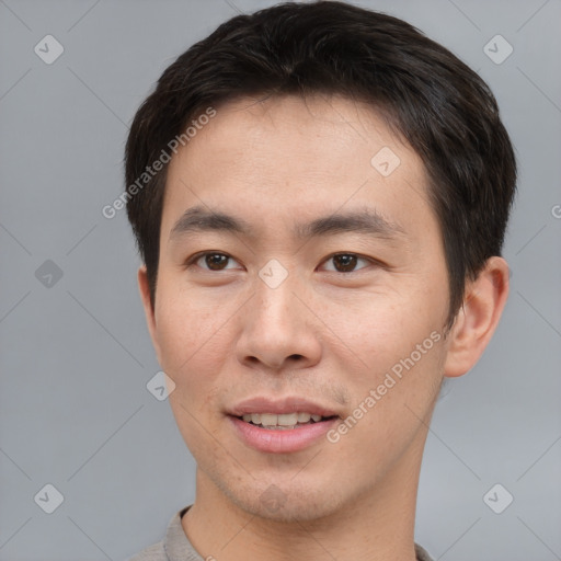 Joyful asian young-adult male with short  brown hair and brown eyes