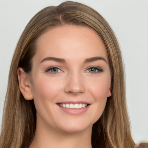 Joyful white young-adult female with long  brown hair and grey eyes