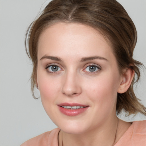 Joyful white young-adult female with medium  brown hair and blue eyes