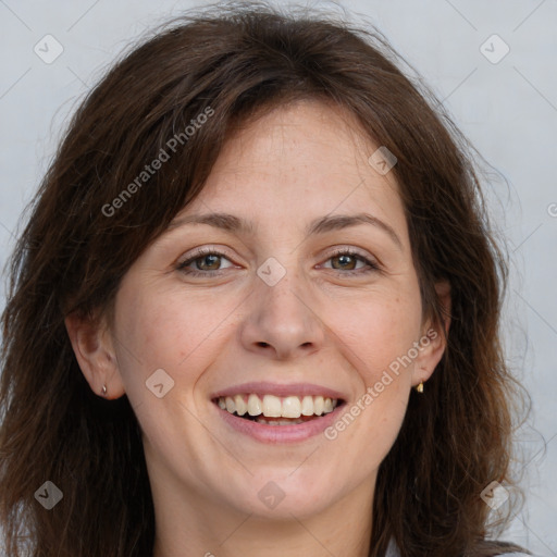 Joyful white adult female with long  brown hair and brown eyes