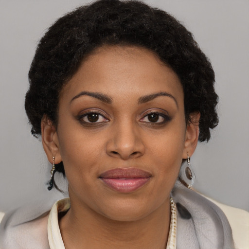 Joyful black young-adult female with short  brown hair and brown eyes