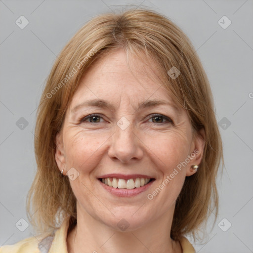 Joyful white adult female with medium  brown hair and brown eyes