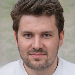 Joyful white adult male with short  brown hair and brown eyes