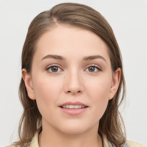 Joyful white young-adult female with medium  brown hair and grey eyes