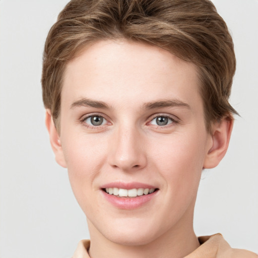 Joyful white young-adult female with short  brown hair and grey eyes