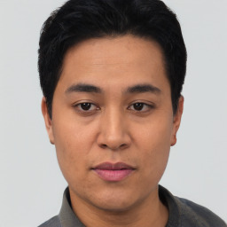 Joyful asian young-adult male with short  black hair and brown eyes