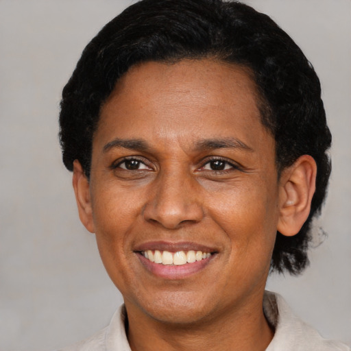 Joyful latino adult female with short  black hair and brown eyes