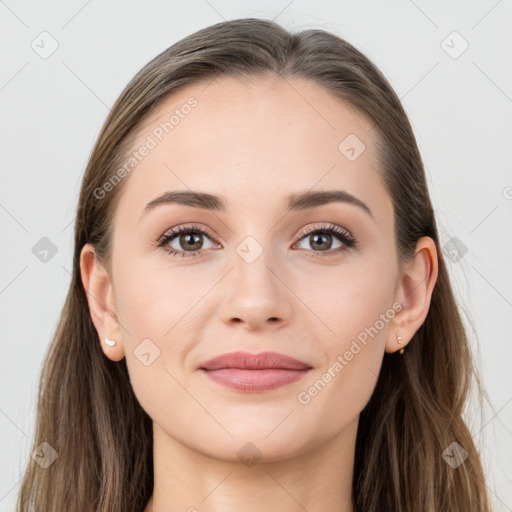 Joyful white young-adult female with long  brown hair and grey eyes