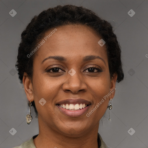 Joyful black adult female with short  brown hair and brown eyes