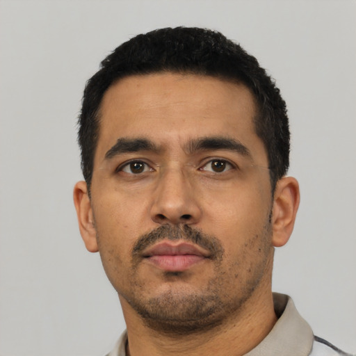 Neutral latino adult male with short  black hair and brown eyes