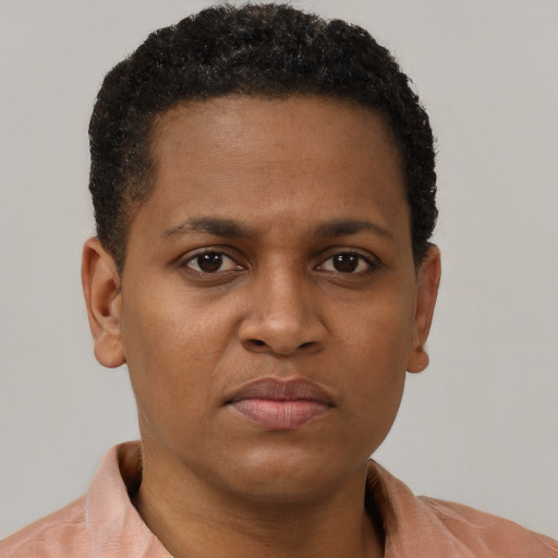 Joyful black young-adult female with short  brown hair and brown eyes
