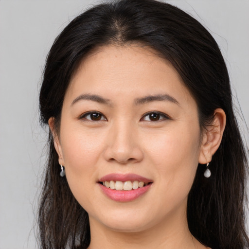 Joyful white young-adult female with long  brown hair and brown eyes