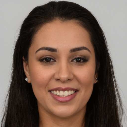 Joyful white young-adult female with long  brown hair and brown eyes