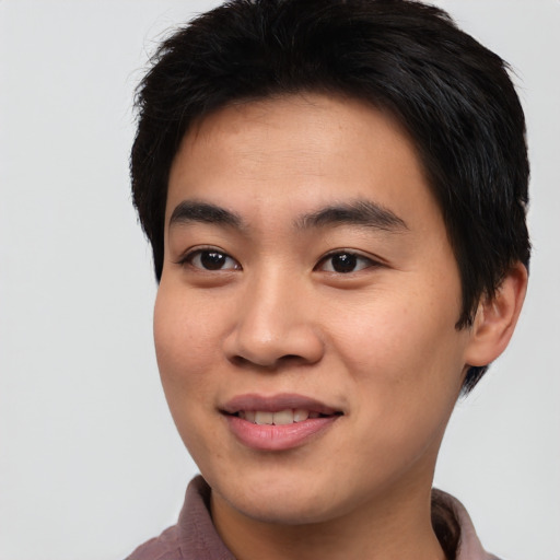 Joyful asian young-adult male with short  black hair and brown eyes