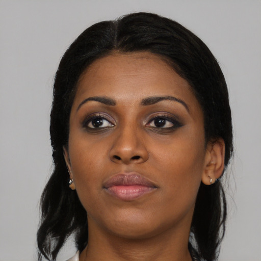 Joyful black young-adult female with medium  black hair and brown eyes