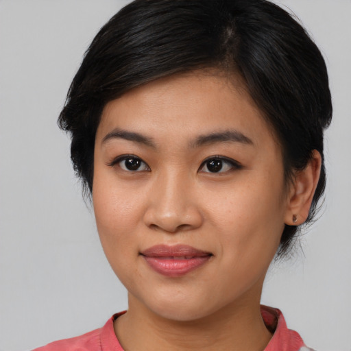 Joyful asian young-adult female with medium  brown hair and brown eyes