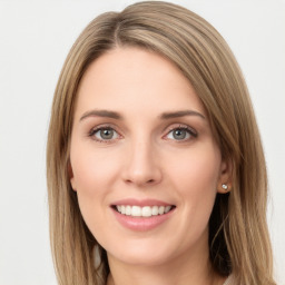 Joyful white young-adult female with long  brown hair and green eyes