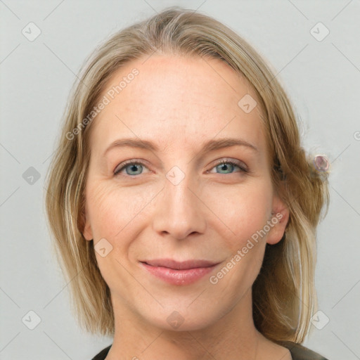 Joyful white adult female with medium  brown hair and blue eyes