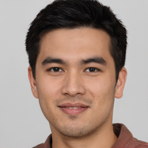 Joyful asian young-adult male with short  black hair and brown eyes