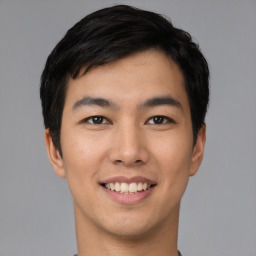 Joyful asian young-adult male with short  black hair and brown eyes