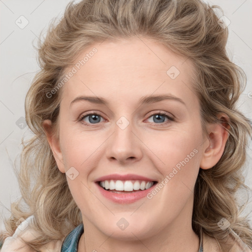 Joyful white young-adult female with medium  brown hair and blue eyes